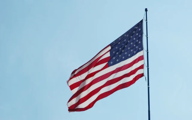 American flag waving against the sky, representing cancellation of removal cases in U.S. immigration court