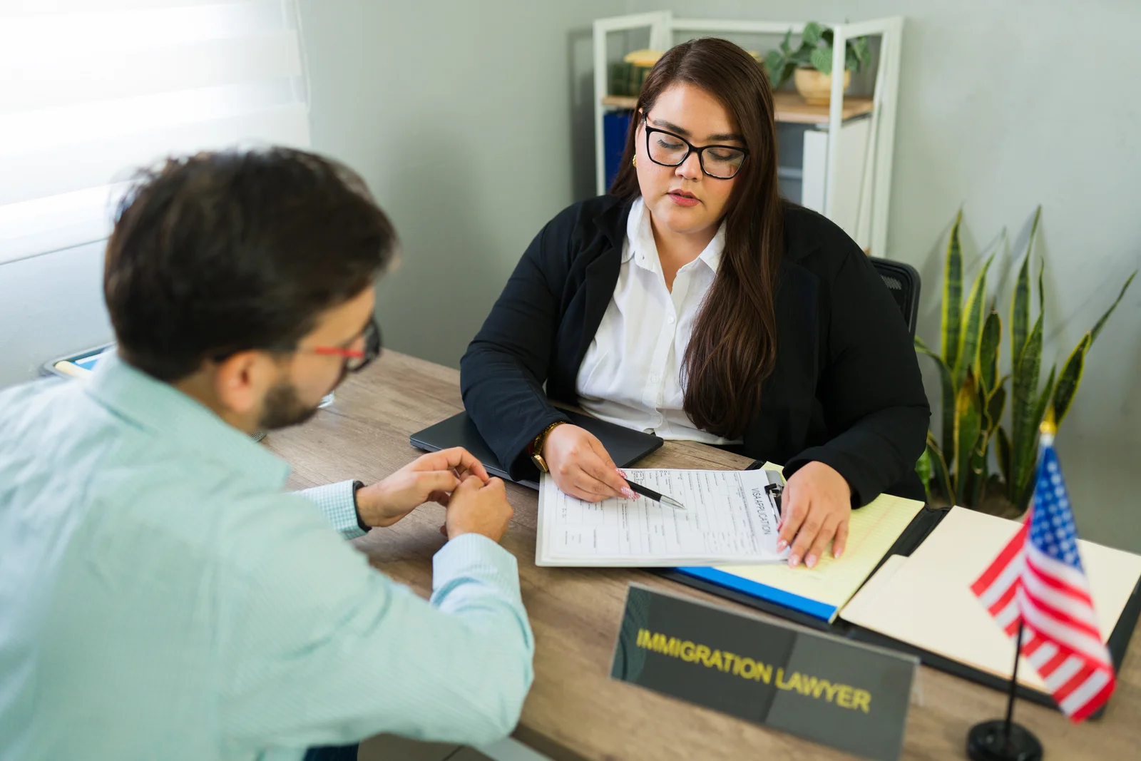 Client reviewing documents with an immigration lawyer to check EOIR-42A or EOIR-42B eligibility