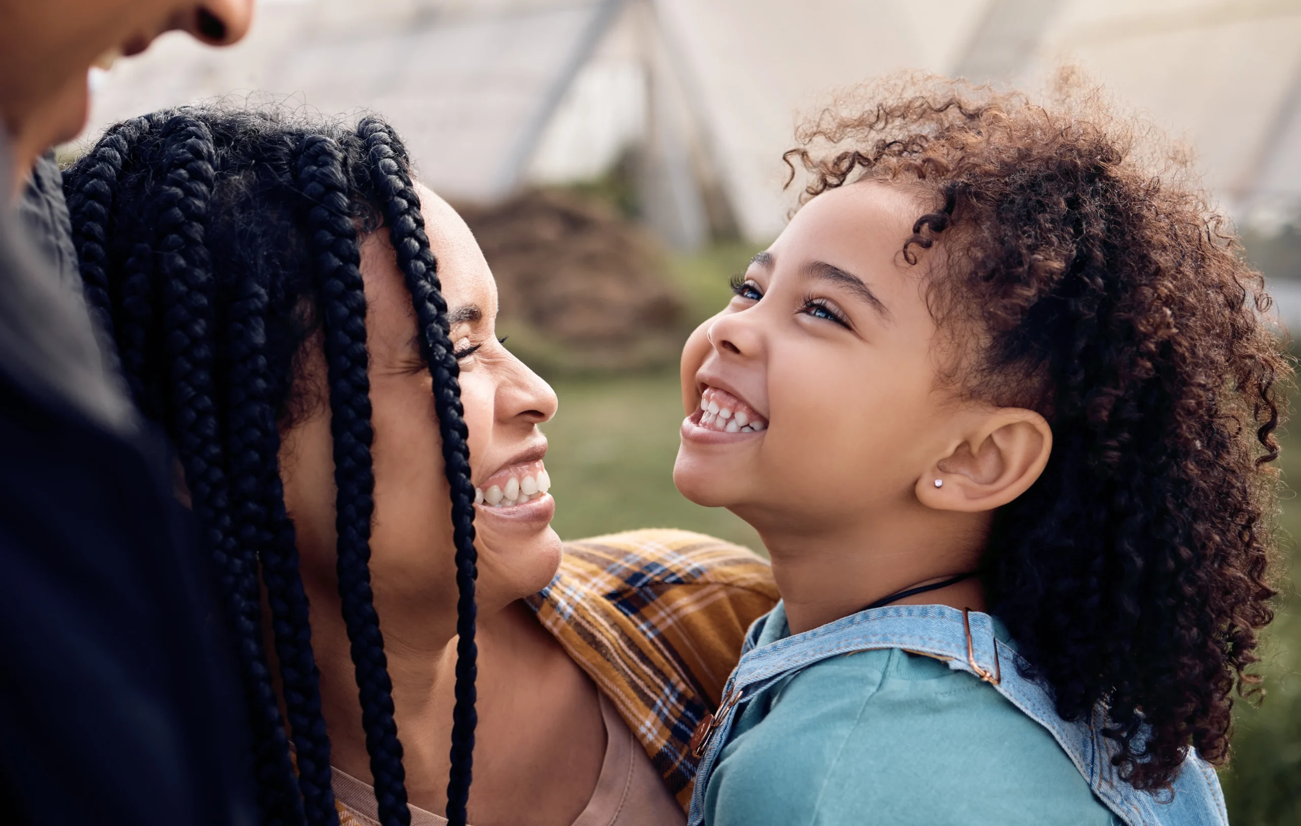 Mother and daughter smiling at each other, illustrating hardship to a U.S. citizen child in a cancellation of removal case