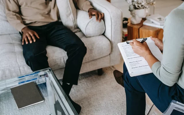 U Visa applicant discussing psychological evaluation with a licensed evaluator during an immigration assessment session