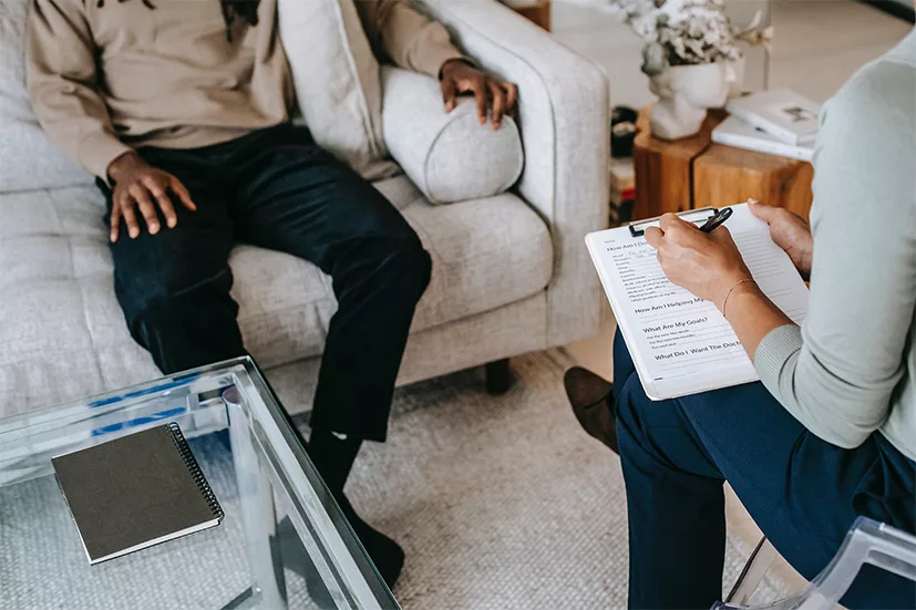 U Visa applicant discussing psychological evaluation with a licensed evaluator during an immigration assessment session